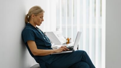 Female healthcare worker using laptop while working at doctor's office