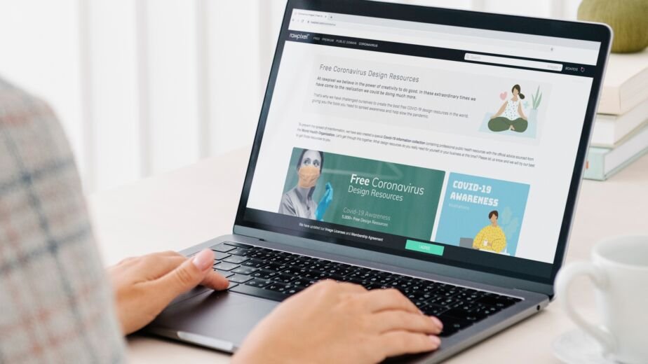 Woman checking out free design resources at a website